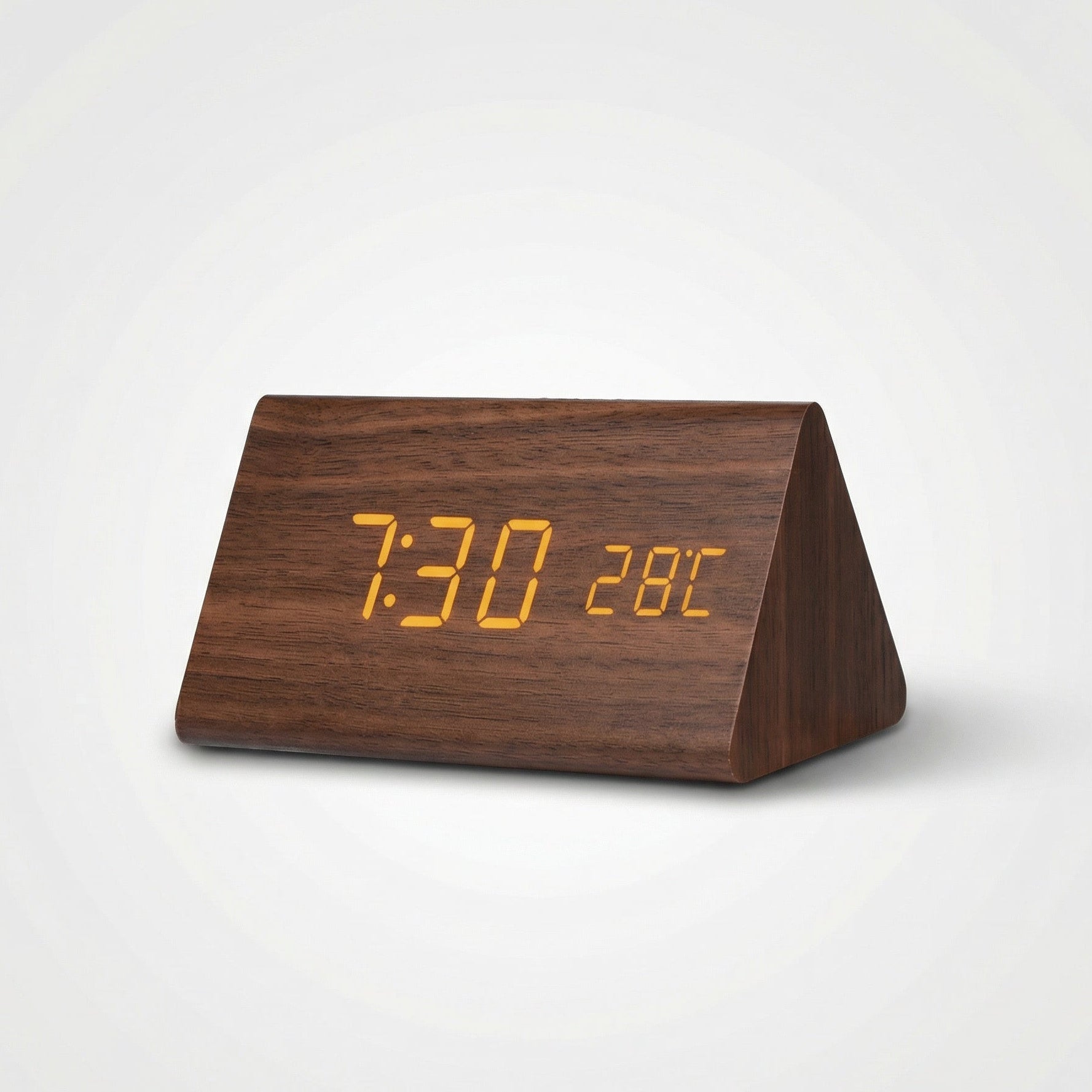 Wooden triangle-shaped digital clock with orange LED display on a white background